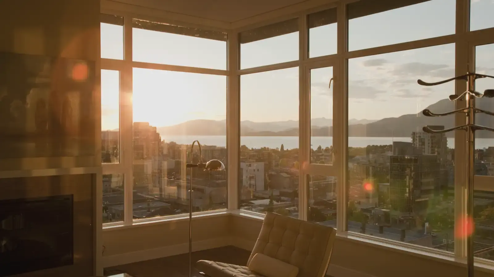Sunset over a city seen through the windows of a quiet apartment.