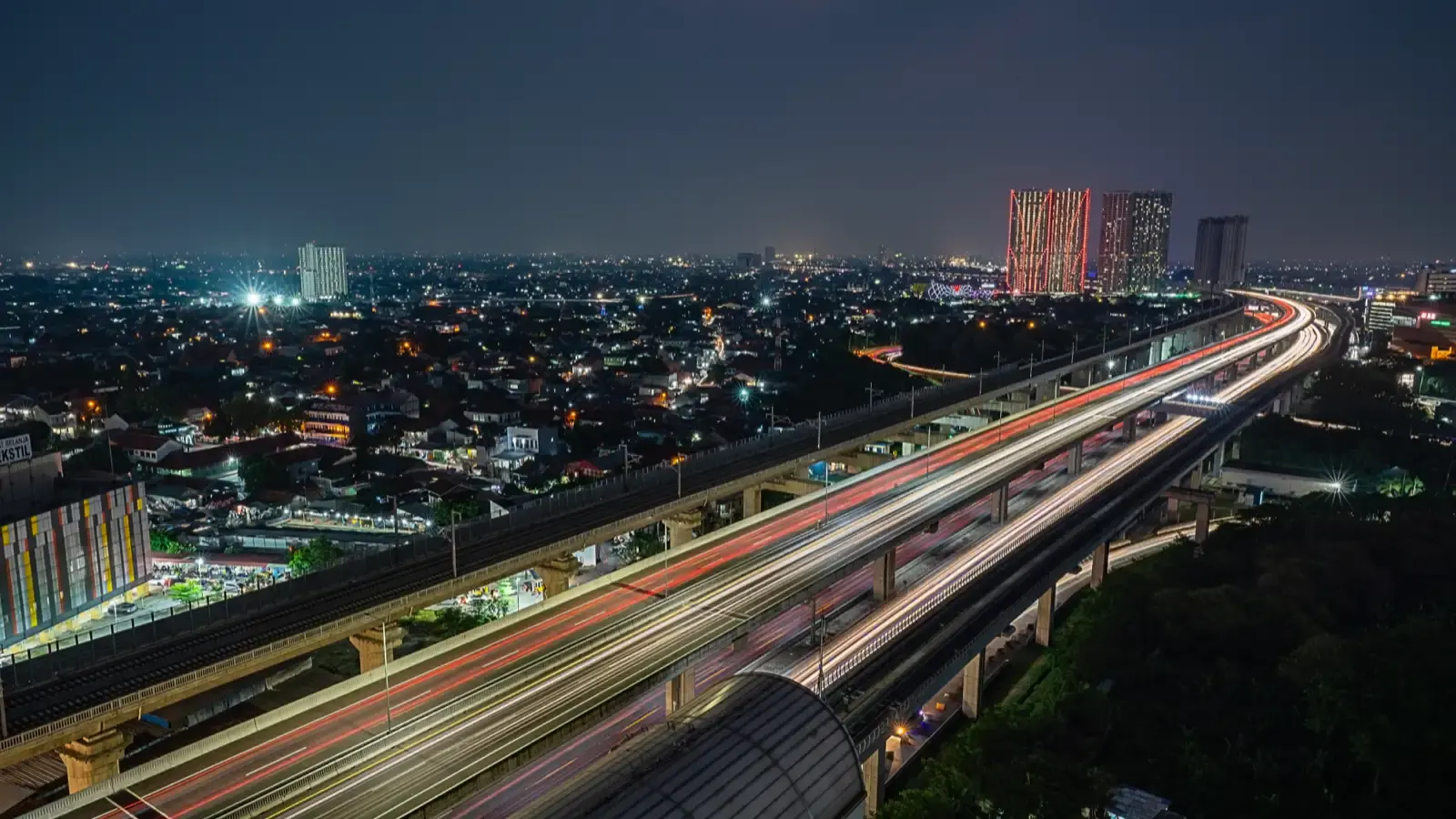 Lampu kendaraan malam hari di jalan tol Jakarta, kota masih terjaga.