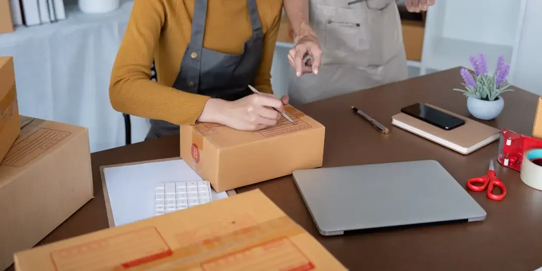 Two people packing orders for an online store.