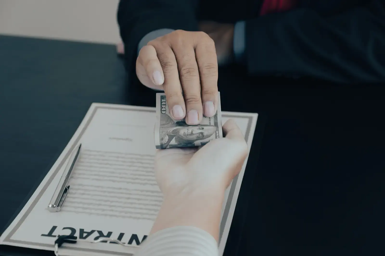 Businessman hand holding dollar bank note money to.