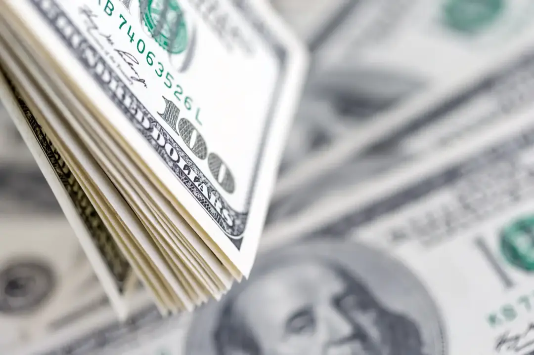 A stack of hundred dollar bills, close up.