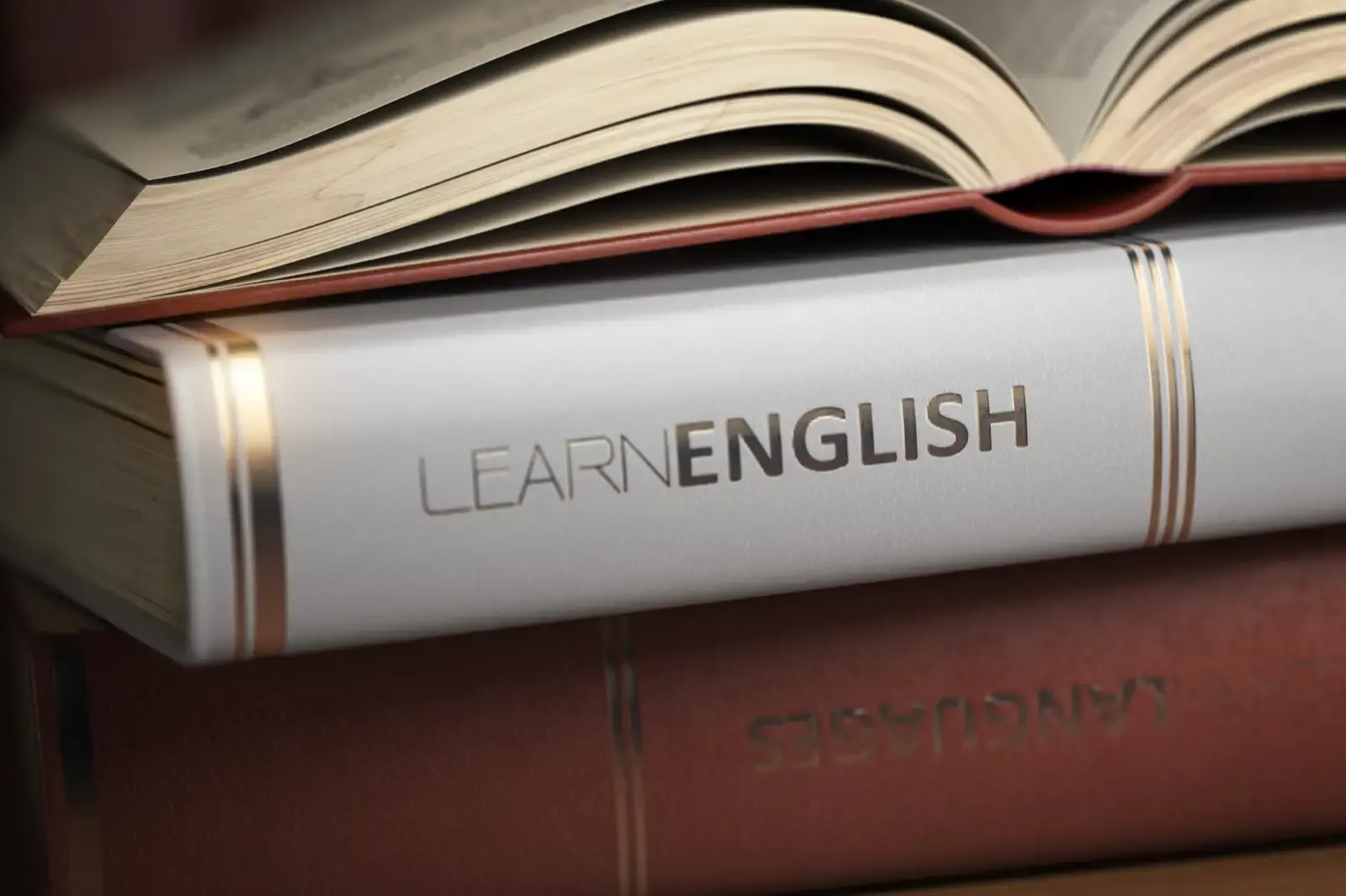 Books stacked with learn english title.