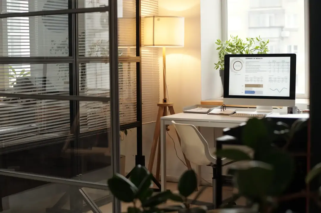 An office interior with a computer on the table.